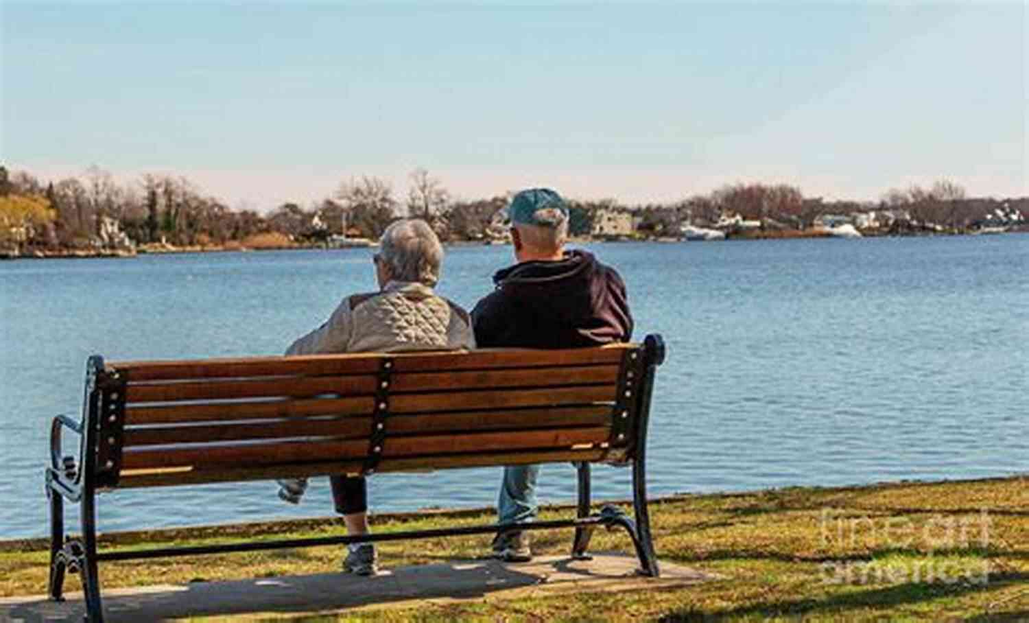 Happy Couple Sitting Together On A Bench Overlooking A Beautiful Sunset Relationships?: Let S Talk About It