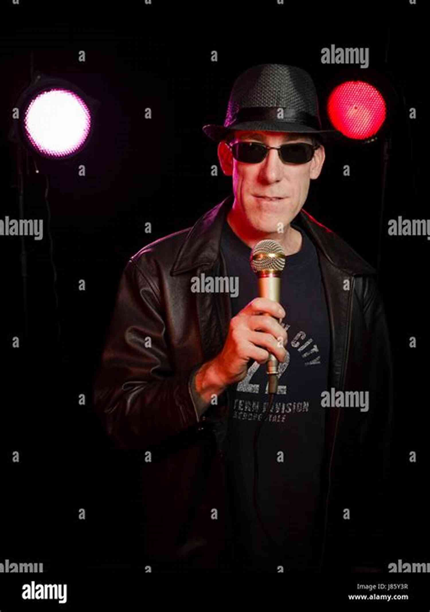 Picture Of Paul Barron, A Stand Up Comedian Performing On A Stage 101 Puntastic Jokes Paul Barron